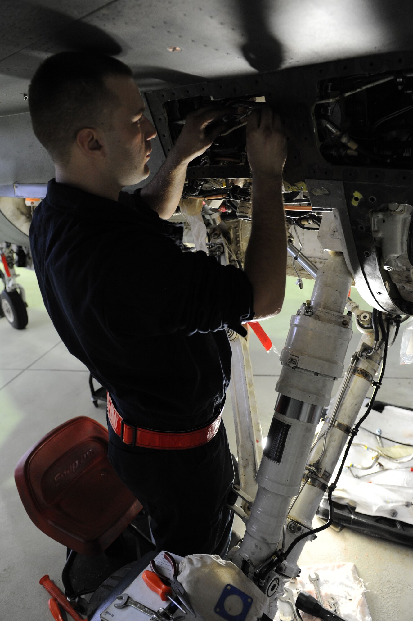 SPANGDAHLEM AIR BASE, Germany – Senior Airman Michael Wylie, 52nd Aircraft Maintenance Squadron tactical aircraft maintainer, installs a hydraulic manifold line on an F-16 Fighting Falcon during maintenance in Hangar 2 here Jan.23. Airmen perform maintence daily with different aircraft rotations to ensure the health of the 52nd Fighter Wing fleet. Wylie works to provide the mission-capable aircraft through scheduled maintenance as part of the 480th Aircraft Maintenance Unit. (U.S. Air Force photo/Senior Airman Christopher Toon)