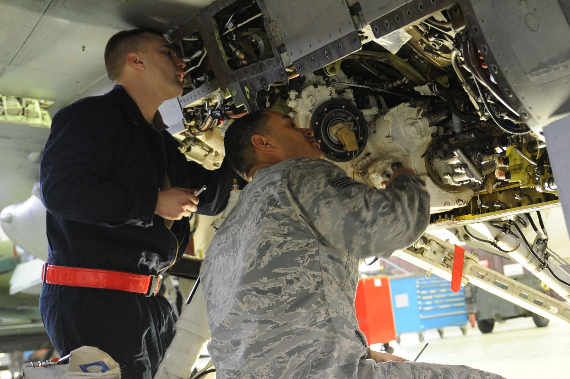 SPANGDAHLEM AIR BASE, Germany – Senior Airman Michael Wylie, 52nd Aircraft Maintenance Squadron tactical aircraft maintainer, and Staff Sgt. Ray Frederick, 52nd Aircraft Maintenance Squadron electric environmental technician, re-route a wire harness during maintenance on an F-16 Fighting Falcon in Hangar 2 here Jan. 23. Airmen perform maintence daily with different aircraft rotations to ensure the health of the 52nd Fighter Wing fleet. Wylie and Frederick work to provide the wing mission-capable aircraft through scheduled maintenance as part of the 480th Aircraft Maintenance Unit. (U.S. Air Force photo/Senior Airman Christopher Toon)