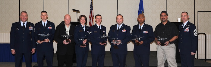 Colonel Erik Hansen (left) and Chief Master Sgt. Larry Williams (right) recognize Staff Sgt. Shawn Goggin, Richard Larkins, Capt. Rebecca Logan, Senior Airman Ronald Sangston, Master Sgt. Christopher Wilson, 1st Lt. Roy Jefferson and Jeremy Olive as the 437th Airlift Wing Quarterly Award winners during a ceremony Jan. 19 at the Charleston Club. Hansen is the 437th AW commander, Williams is the 437th AW command chief, Goggin is from the 14th Airlift Squadron, 437th AW, Larkins is from the 437th Maintenance Squadron, Logan is from the 437th Aircraft Maintenance Squadron, Sangston is from the 437th AMXS, Wilson is  from the 437th Maintenance Operations Squadron, Jefferson is from the 437th Aerial Port Squadron and Olive is from the 437th APS. Not pictured is Tech. Sgt. Michael Morris from the 15th Airlift Squadron, 437th AW. (U.S. Air Force photo/Airman First Class Ashlee Galloway).