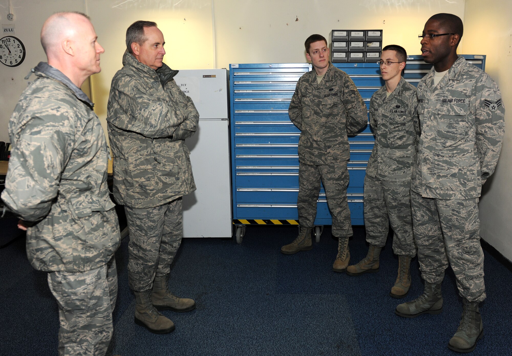 RAF MOLESWORTH, United Kingdom – Senior Airman Daniel Postell (far right), 421st Air Base Squadron, briefs Gen. Mark A. Welsh III, U.S. Air Forces in Europe commander, and USAFE Command Chief David Williamson about postal operations at RAF  Menwith Hill Jan. 20. Postell, along with Senior Airman Colin Hart, 423rd Communications Squadron, and Airman First Class Charles Fletcher, 422nd CS, briefed  Welsh and Williamson about postal and communications operations within the 501st Combat Support Wing. (U.S. Air Force photo by Senior Airman Joel Mease)
