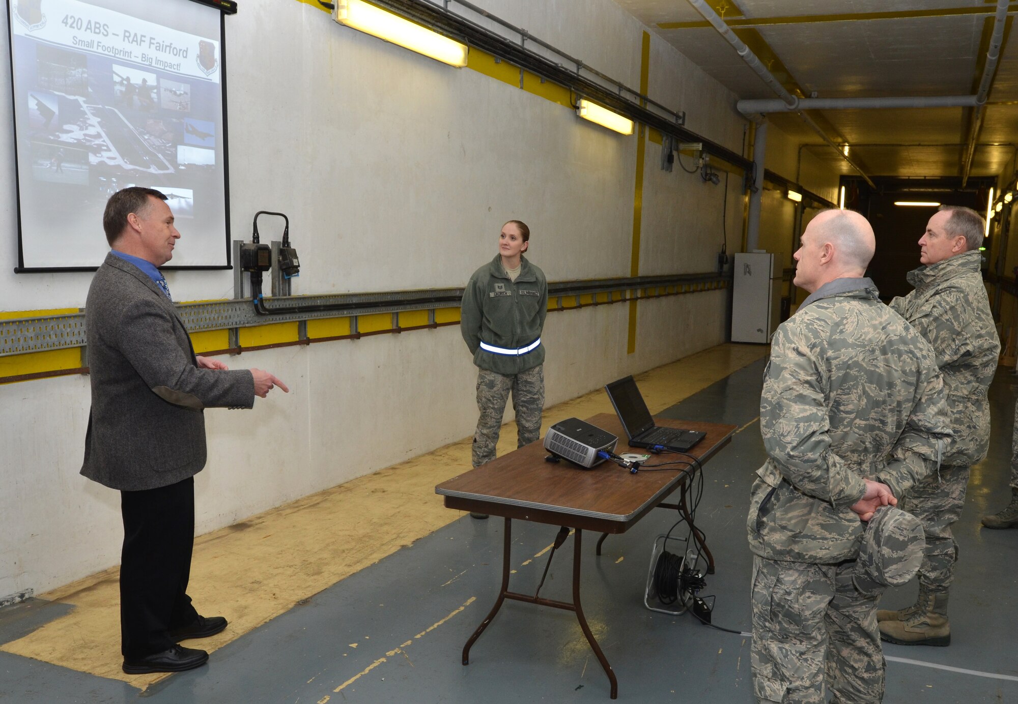 RAF MOLESWORTH, United Kingdom -- Timothy Hershberger (left), 420th Air Base Squadron site director, explains to Gen. Mark A. Welsh III, U.S. Air Forces in Europe commander, and Chief Master Sgt. David Williamson, USAFE command chief, Royal Air Force Fairford’s capabilities to host global strike operations during a briefing, here, Jan. 20. (U.S. Air Force Photo by Tech. Sgt. John Barton)