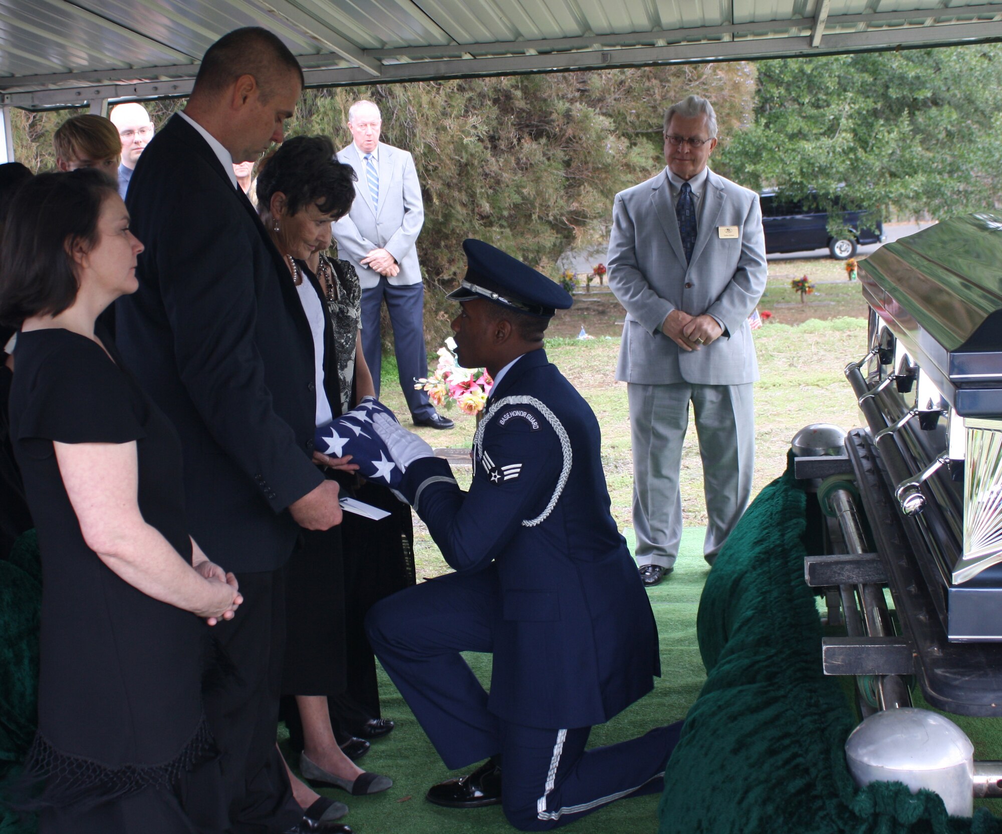 Senior Airman Princeton Drake, Barksdale Honor Guard Bravo Flight leader, presents a folded flag to a next-of-kin in Houghton, La., Jan. 16. Honor Guard Airmen prepare for moments like this when strong, military bearing is a necessity. (Courtesy photo)(RELEASED)