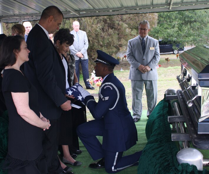 Senior Airman Princeton Drake, Barksdale Honor Guard Bravo Flight leader, presents a folded flag to a next-of-kin in Houghton, La., Jan. 16. Honor Guard Airmen prepare for moments like this when strong, military bearing is a necessity. (Courtesy photo)(RELEASED)