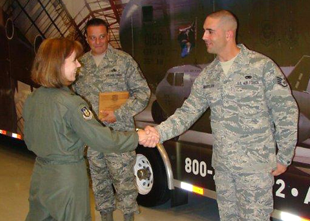 The Vice Commander of 4th Air Force, Brig. Gen. Pamela Milligan congratulates Staff Sgt. Matthew J. Mihiylov, 315th Aircraft Maintenance Squadron, for being selected as 4th Air Force 2011 Chief Master Sgt. Thomas N. Barnes Crew Chief of the Year. (Courtesy Photo)