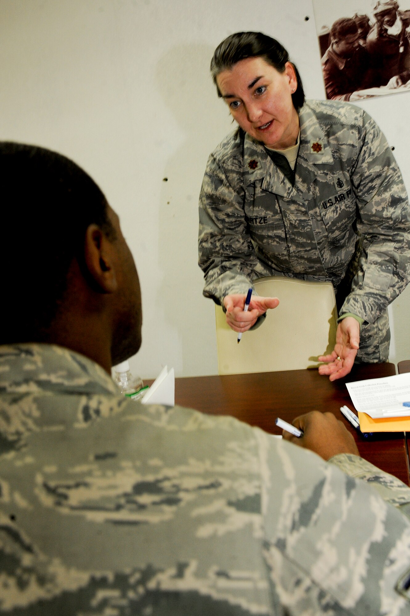 Maj. Rachelle Hartze, 332nd Expeditionary Medical Group, talks with a potential donor about the Department of Defense Marrow Donor Program during a bone marrow registry drive in the Huntley Dining Facility at an undisclosed location in Southwest Asia, Jan. 22, 2012. Since the program started in 1986, more than 400,000 service members have become donors. Hartze is deployed from Ellsworth Air Force Base, N.D., and is a native of Faulkton, S.D. (U.S. Air Force photo by Staff Sgt. Joshua J. Garcia/Released)