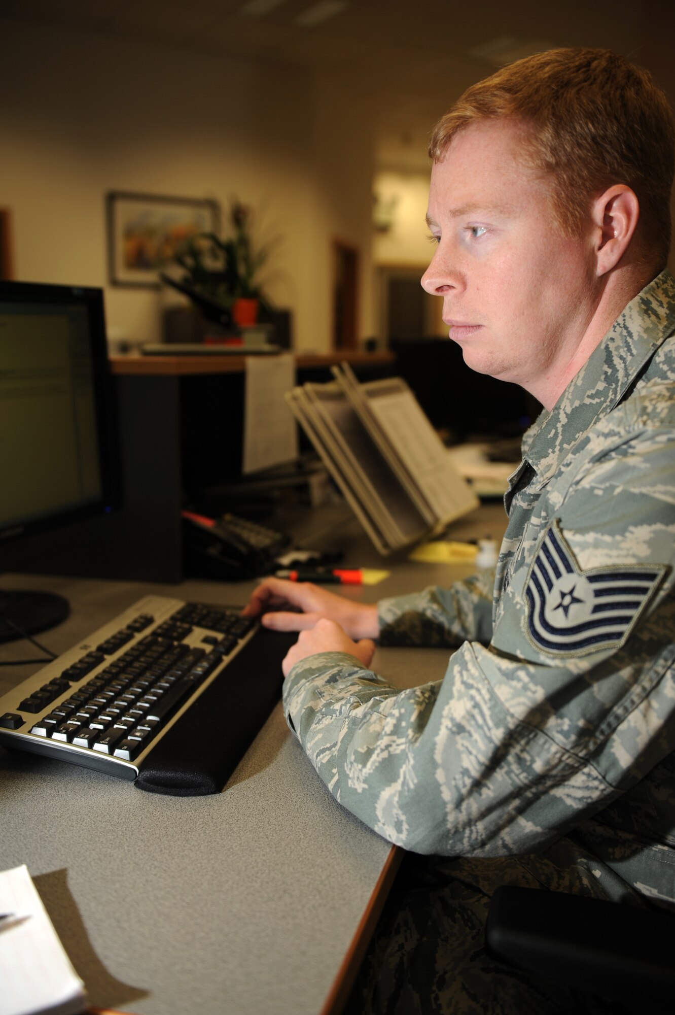 SPANGDAHLEM AIR BASE, Germany – Tech. Sgt. Jesse Smith, 52nd Civil Engineer Squadron NCO in charge of customer service, processes work-order requests at the CES customer service desk at Bldg. 120 here Jan. 19. CES processes and organizes more than 1,100 work orders a month requesting base maintenance, repairs and construction to be fulfilled by the 52nd CES and local contractors. (U.S. Air Force photo/Airman 1st Class Matthew B. Fredericks)