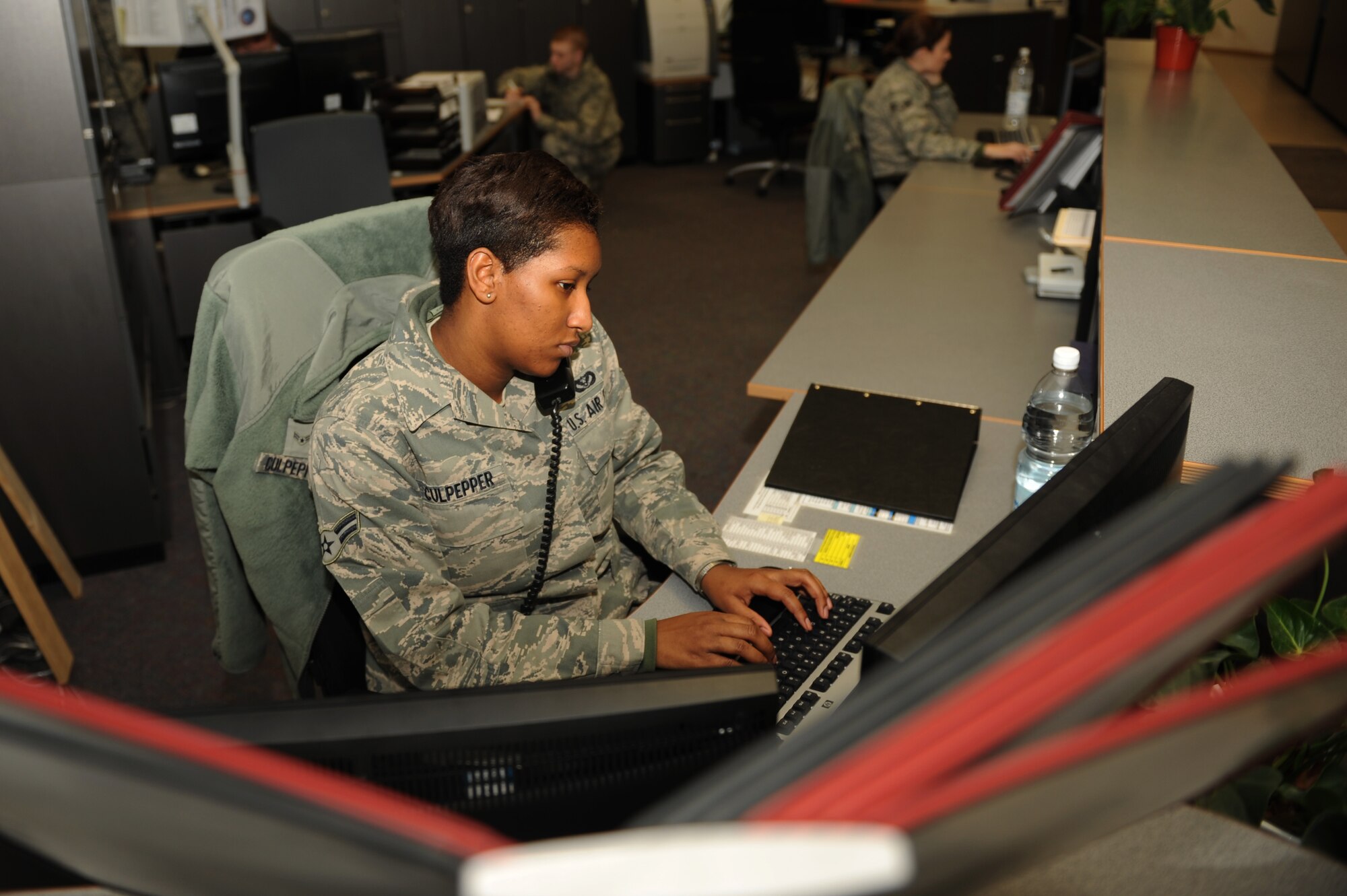 SPANGDAHLEM AIR BASE, Germany –Airman 1st Class Diamond Culpepper, 52nd Civil Engineer Squadron operations management apprentice, receives a call from a customer at the CES customer service desk at Bldg. 120 here Jan. 19. CES processes and organizes more than 1,100 work orders a month requesting base maintenance, repairs and construction to be fulfilled by the 52nd CES and local contractors. (U.S. Air Force photo/Airman 1st Class Matthew B. Fredericks)