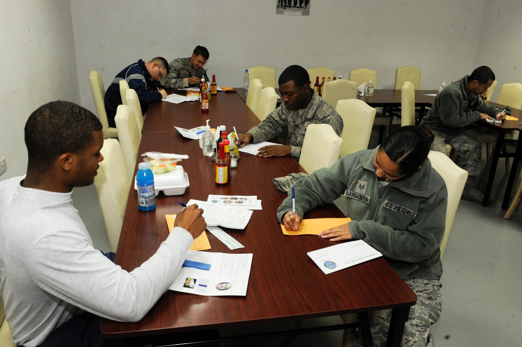 Members of the 332nd Air Expeditionary Wing fill out registry forms to become bone marrow donors in the Huntley Dining Facility at an undisclosed location in Southwest Asia, Jan. 22, 2012. The entire process took about 15 minutes to complete and consisted of filling out a registration form and swabbing the inner cheek for a DNA sample. (U.S. Air Force photo by Staff Sgt. Joshua J. Garcia/Released)