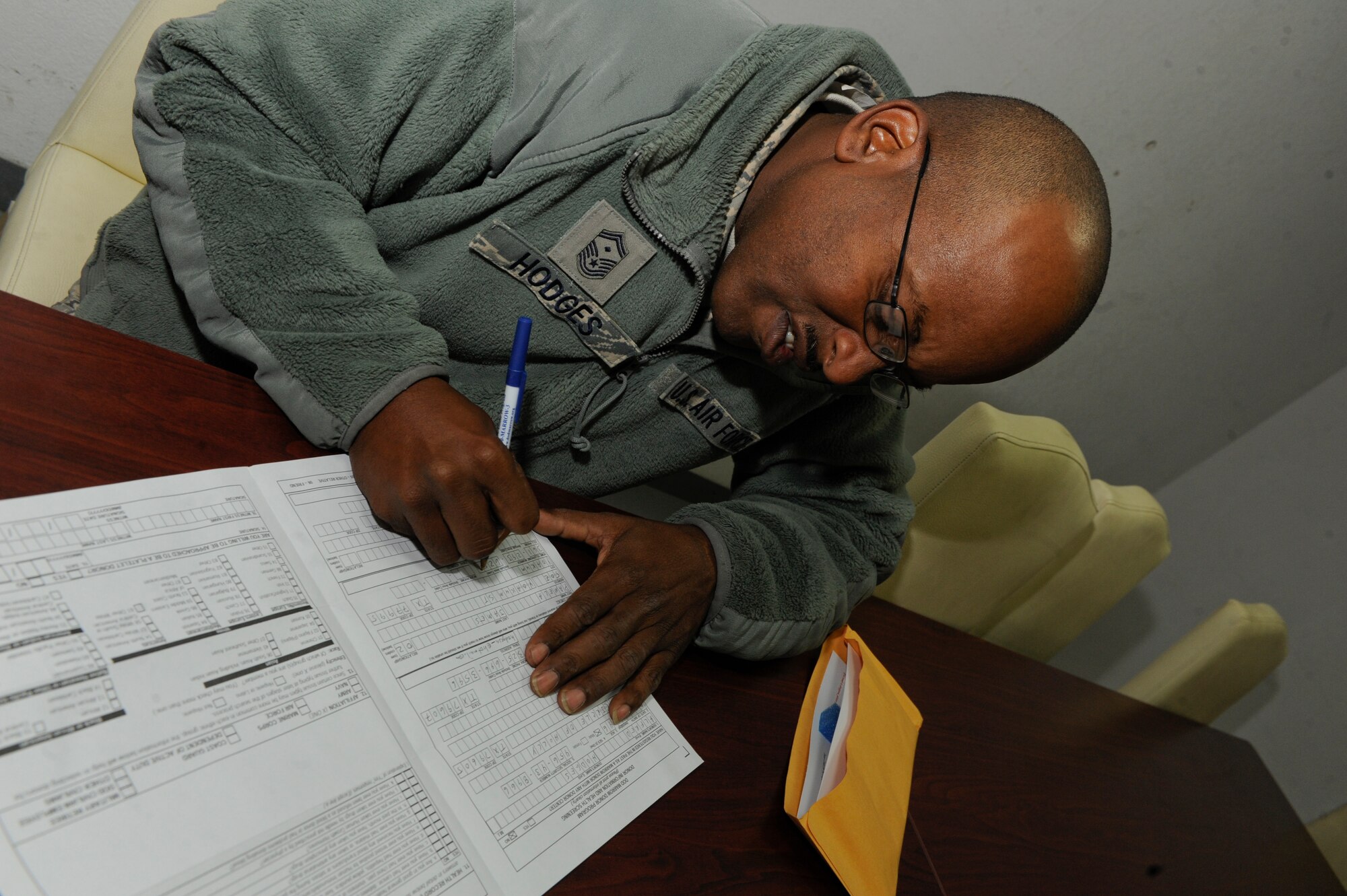 Senior Master Sgt. Alfred Hodges, 332nd Expeditionary Civil Engineer Squadron first sergeant, fills out a bone marrow donor registry form at an undisclosed location in Southwest Asia, Jan. 22, 2012. Members of the 332nd Expeditionary Medical Group held a marrow drive Jan. 21-22, to get maximum base participation. Hodges is deployed from Dyess Air Force Base, Texas, and is a native of Yoakum, Texas. (U.S. Air Force photo by Staff Sgt. Joshua J. Garcia/Released)