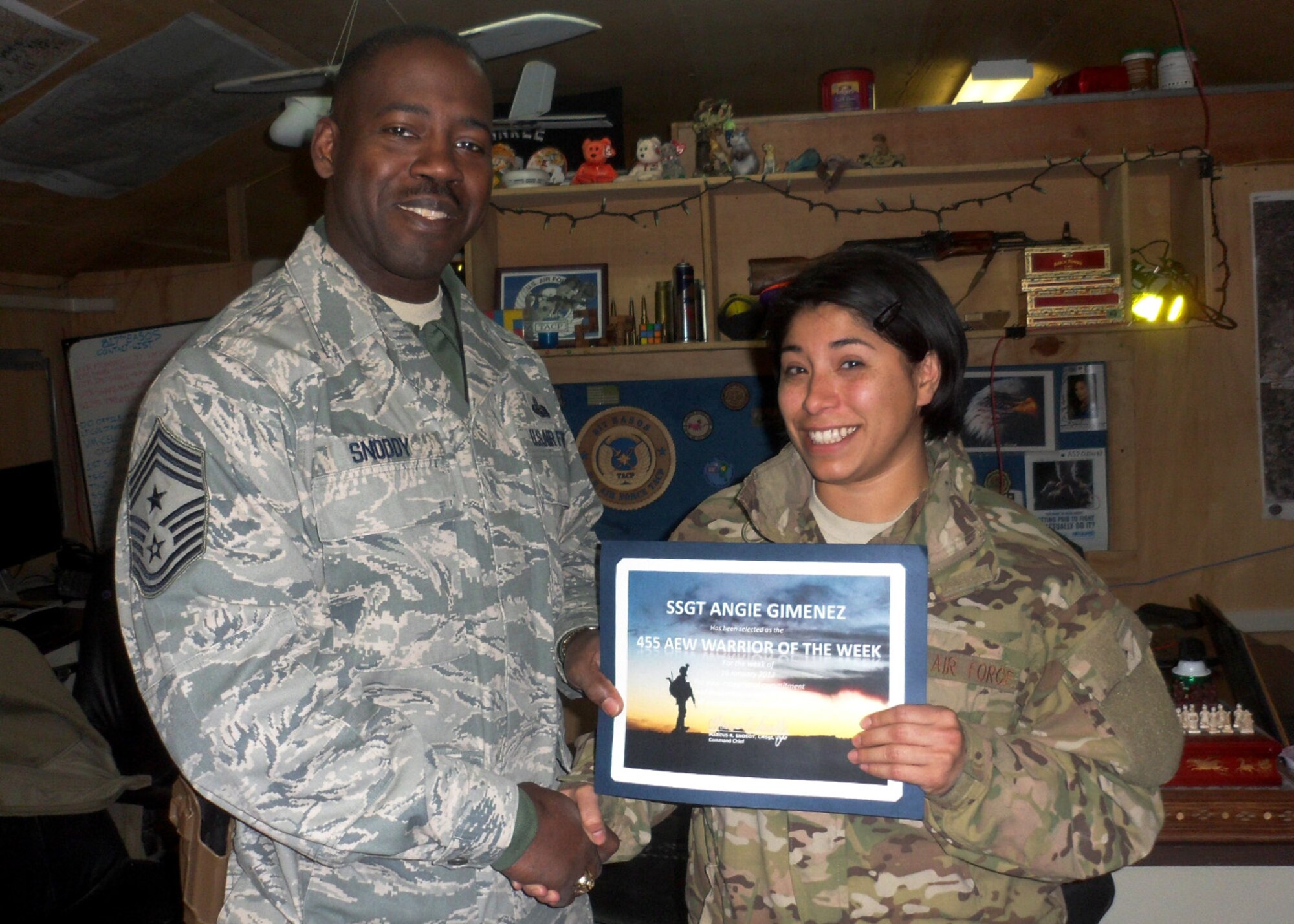 BAGRAM AIRFIELD, Afghanistan—Staff Sgt. Angie B. Gimenez receives the Warrior of the Week award from Chief Master Sgt. Marcus Snoddy at Bagram Airfield, Afghanistan, Jan. 22, 2012. Gimenez is the noncommissioned officer in charge of the Commander Support Section with the 817th Expeditionary Air Support Operations Squadron and earned the Warrior of the Week award for her hard work and dedication to excellence.(U.S. Air Force photo/Staff Sgt. Elena Eisenbarth)