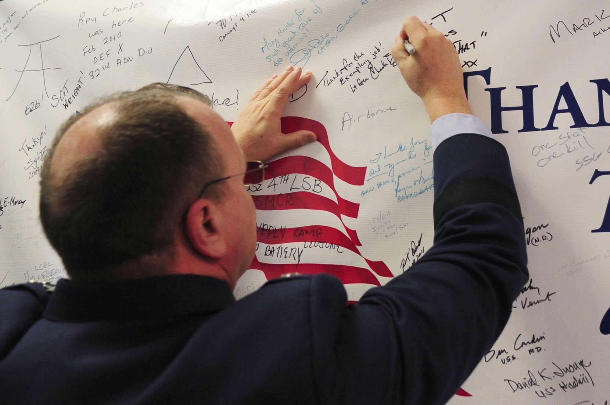 Lt. Gen. Charles B. Green, Air Force surgeon general, signs a banner during his visit to the 86th Contingency Aeromedical Staging Facility, Ramstein Air Base, Germany, Jan. 23, 2012. The purpose of his visit was to assess the capabilities of the 86th Medical Group and to visit with Airmen from the unit. (U.S. Air Force photo by Senior Airman Brittany Perry)