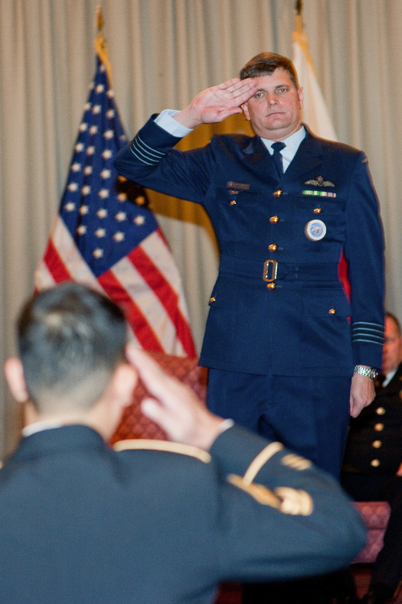 YOKOTA AIR BASE, Japan -- Royal Australian Air Force Group Captain Luke Stoodley, United Nations Command (Rear) commander, renders his first salute as commander during a change of command ceremony at Yokota Air Base, Japan, Jan. 24, 2012. Stoodley assumed command from Group Captain Anthony McCormack. (U.S. Air Force photo/Osakabe Yasuo) 