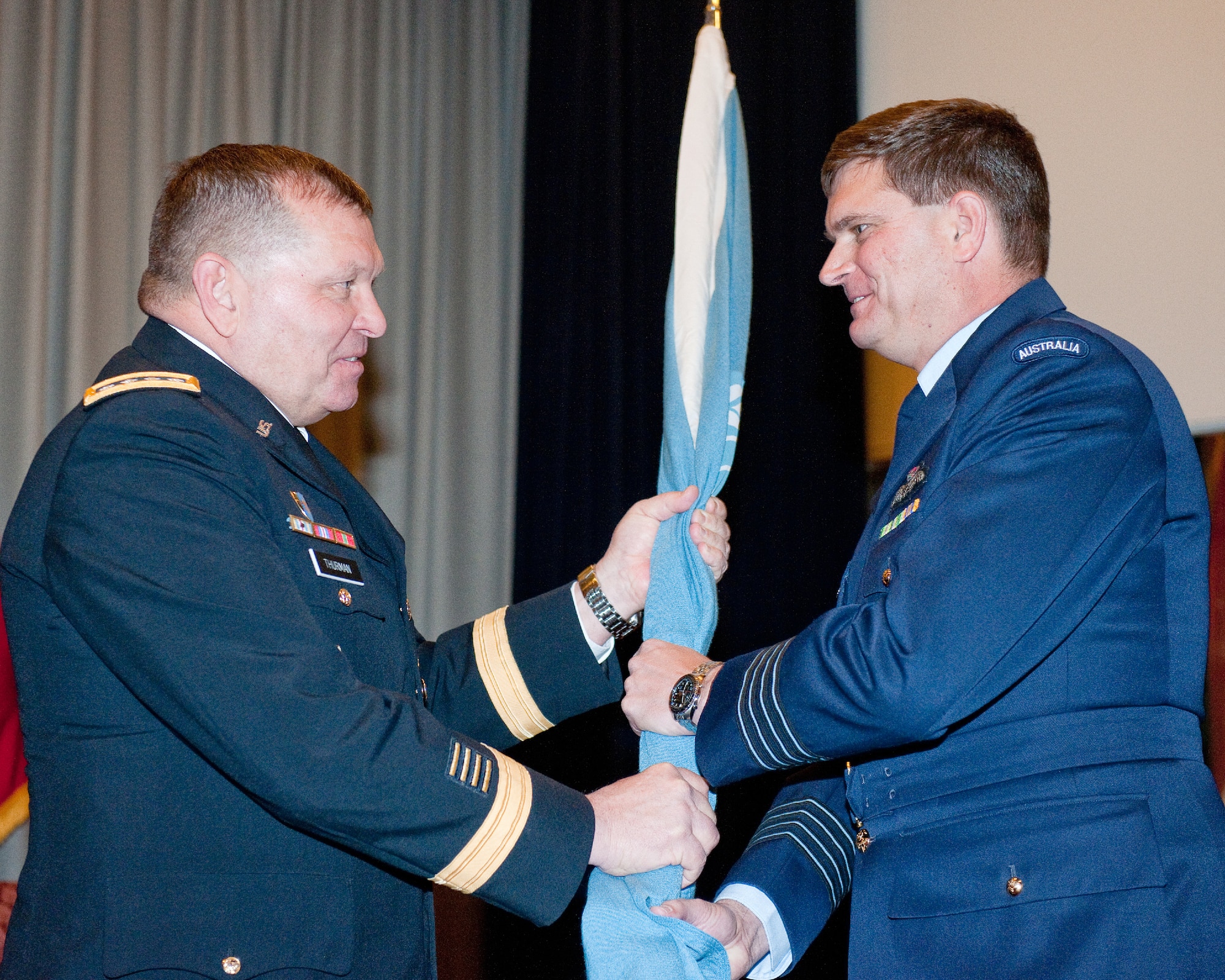 YOKOTA AIR BASE, Japan – (right to left) Royal Australian Air Force Group Captain Luke Stoodley, incoming United Nations Command (Rear) commander, receives the guidon from U.S. Army Gen. James Thurman, Commander of the Republic of Korea-based United Nations Command,  during a change of command ceremony at Yokota Air Base, Japan, Jan. 24, 2012. The UNC's principal representative in Japan, the UNC (Rear) maintains the status of forces agreement regarding United Nations Forces in Japan during armistice conditions. (U.S. Air Force photo/Osakabe Yasuo)