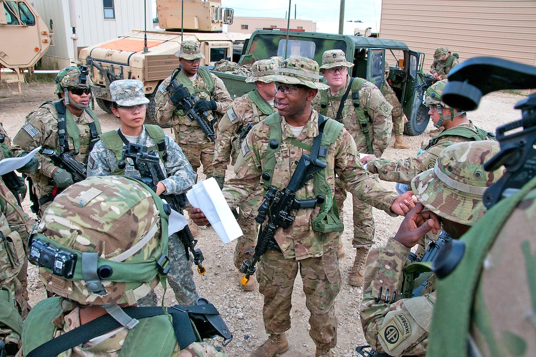 Army Spc. Phillip Walker, center, briefs soldiers before they conduct a resupply mission to one of the brigade’s infantry companies during force-on-force operations at the Joint Readiness Training Center, Fort Polk, La., Jan. 22, 2012. Walker is a a paratrooper assigned to the 82nd Airborne Division’s 1st Brigade Combat Team. The paratroopers are part of a forward support company that serves a battalion of light infantry.