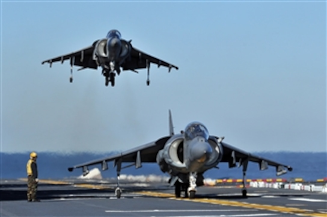 Two AV-8B Harrier II aircraft assigned to Marine Attack Squadron 542 conduct flight operations aboard the USS Kearsarge (LHD 3) in the Atlantic Ocean on Jan. 19, 2012.  The amphibious assault ship is conducting crew certifications in preparation for future amphibious operations.  