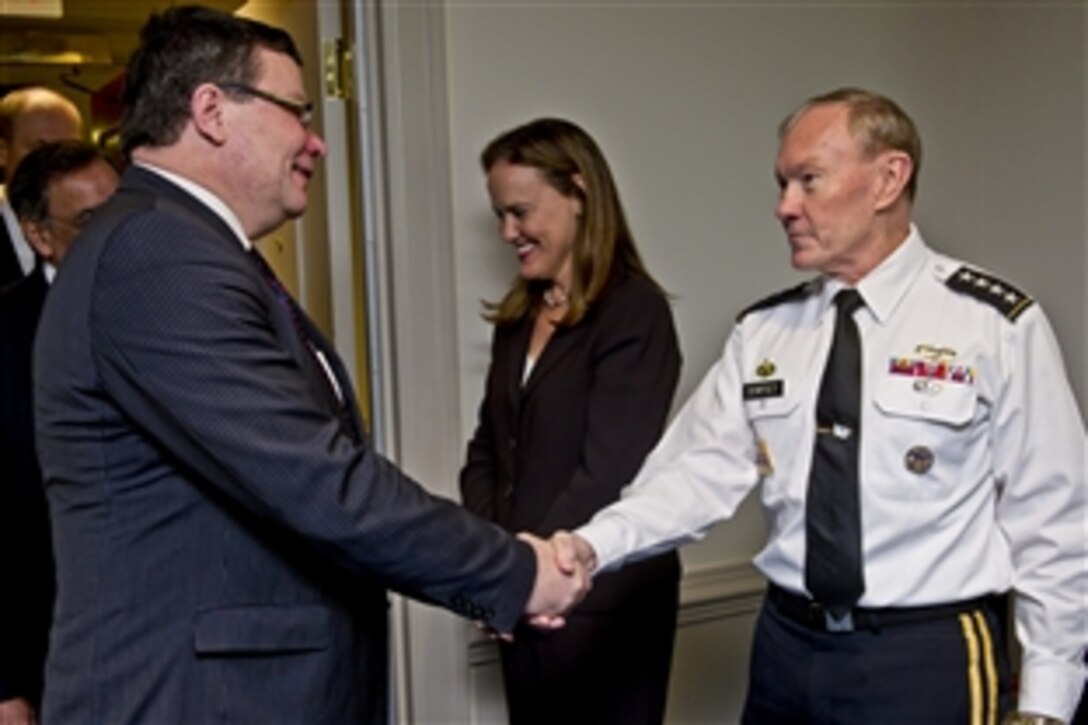 U.S. Army Gen. Martin E. Dempsey, chairman of the Joint Chiefs of Staff, right, shakes hands with Czech Defense Minister Alexandr Vondra, left, while Michele Flournoy, undersecretary of defense for policy, center, looks on at the Pentagon, Jan. 24, 2012.