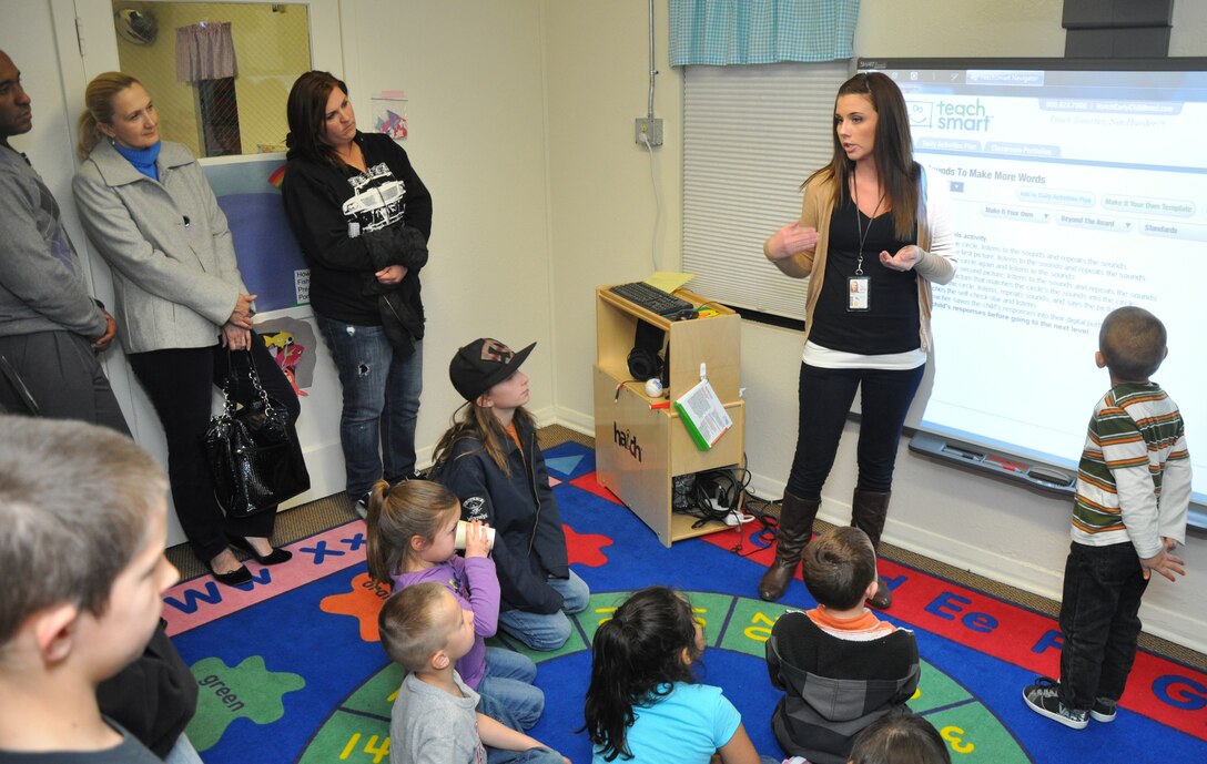 Taylor Cardova, a program assistant with the Child Development Center aboard Marine Corps Logistics Base Barstow Calif., explains to parents of children of the CDC the functions of their smartboard, a new addition to the CDC in their efforts to incorporate more technology into their curriculum during the open house held Jan. 24. The open house was held to afford parents of the children at the CDC an opportunity to find out information about the programs offered there.
