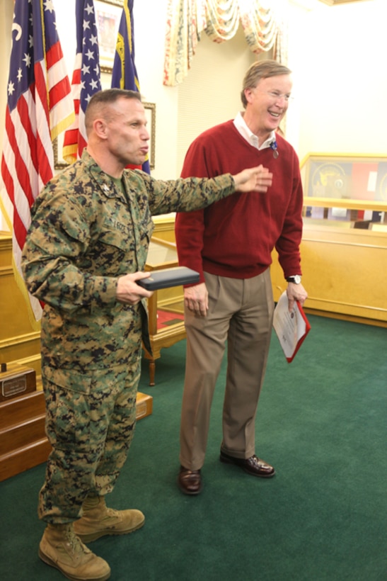 Col. Daniel J. Lecce, Marine Corps Base Camp Lejeune commanding officer awards Fred Cone, former Deputy Assistant Chief of Staff for Installations, Facilities and Environment, Marine Corps Installations East, and the Deputy Director, Installations and Environment Department, MCB Camp Lejeune for his superior civilian service on the quarterdeck of Building 1 aboard MCB Camp Lejeune, Jan. 25.