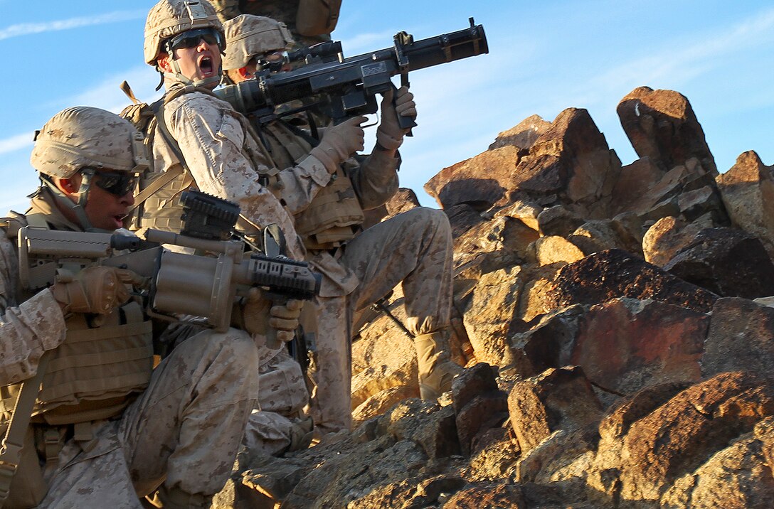 Marines of 2nd Platoon, 1st Battalion, 7th Marine Regiment prepare to shoot the shoulder-launched multipurpose assualt weapon on top of Machine Gun Hill during the first round of live fire exercises held at Range 410 Jan. 25, 2012.