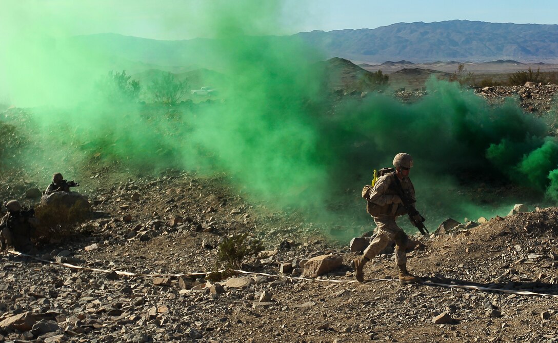 Marines of 1st Platoon, 1st Battalion, 7th Marine Regiment, advances toward a target during the second round of live fire exercises at Range 410 Jan. 25, 2012