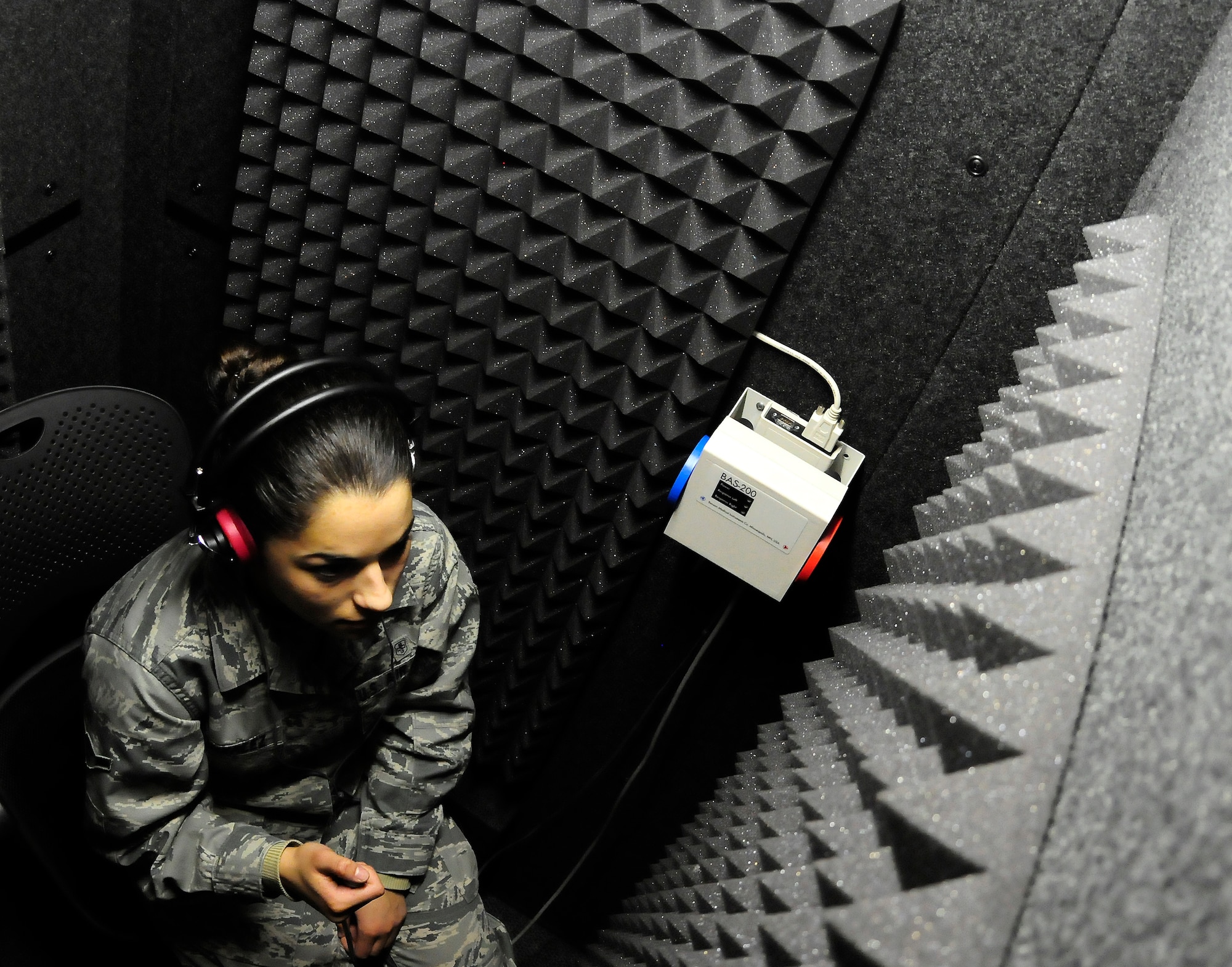 U.S. Air Force Airman Laura Gonzalez is administered a hearing test in the new audiometric testing room located at the medical clinic, Jan. 20, 2012, Eielson Air Force Base, Alaska. The new booth has almost three times the internal volume of the old booths previously used for testing. Gonzalez is a public health apprentice assigned to the 354th Medical Support Squadron. (U.S. Air Force photo by Airman 1st Class Zachary Perras/Released)                                                                                                                                                                                                                                                                                                                 