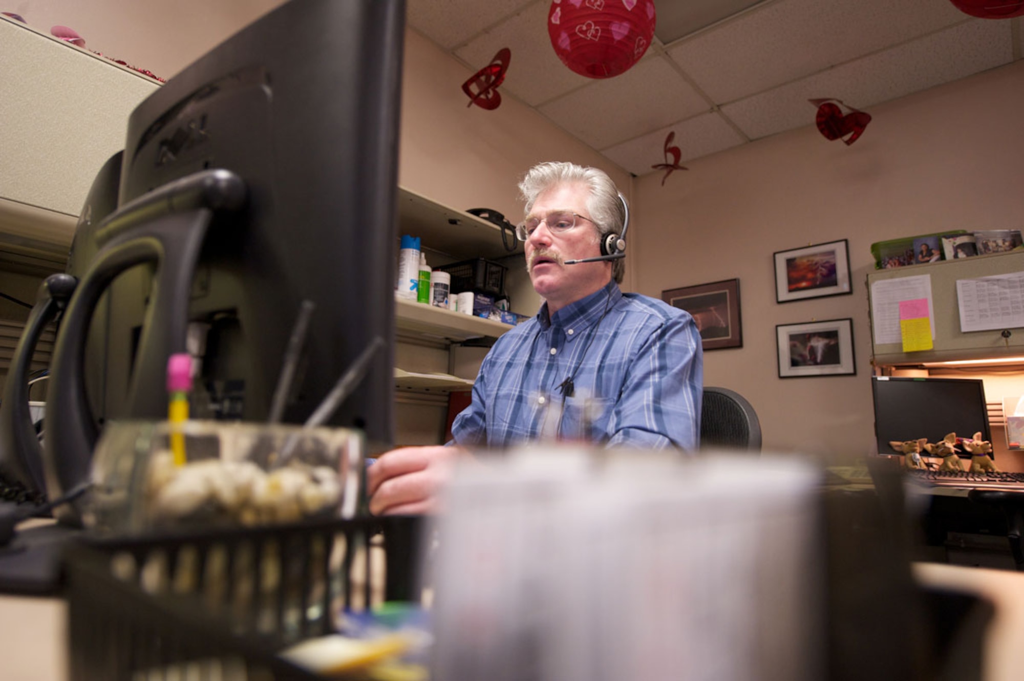 Doug Osborne, Joint Base Elmendorf-Richardson telephone operator, connects a call Jan. 20 at Telephone Operations. The Wasilla native said he most enjoys connecting deployed troops with their families at home. (U.S. Air Force photo/David Bedard)