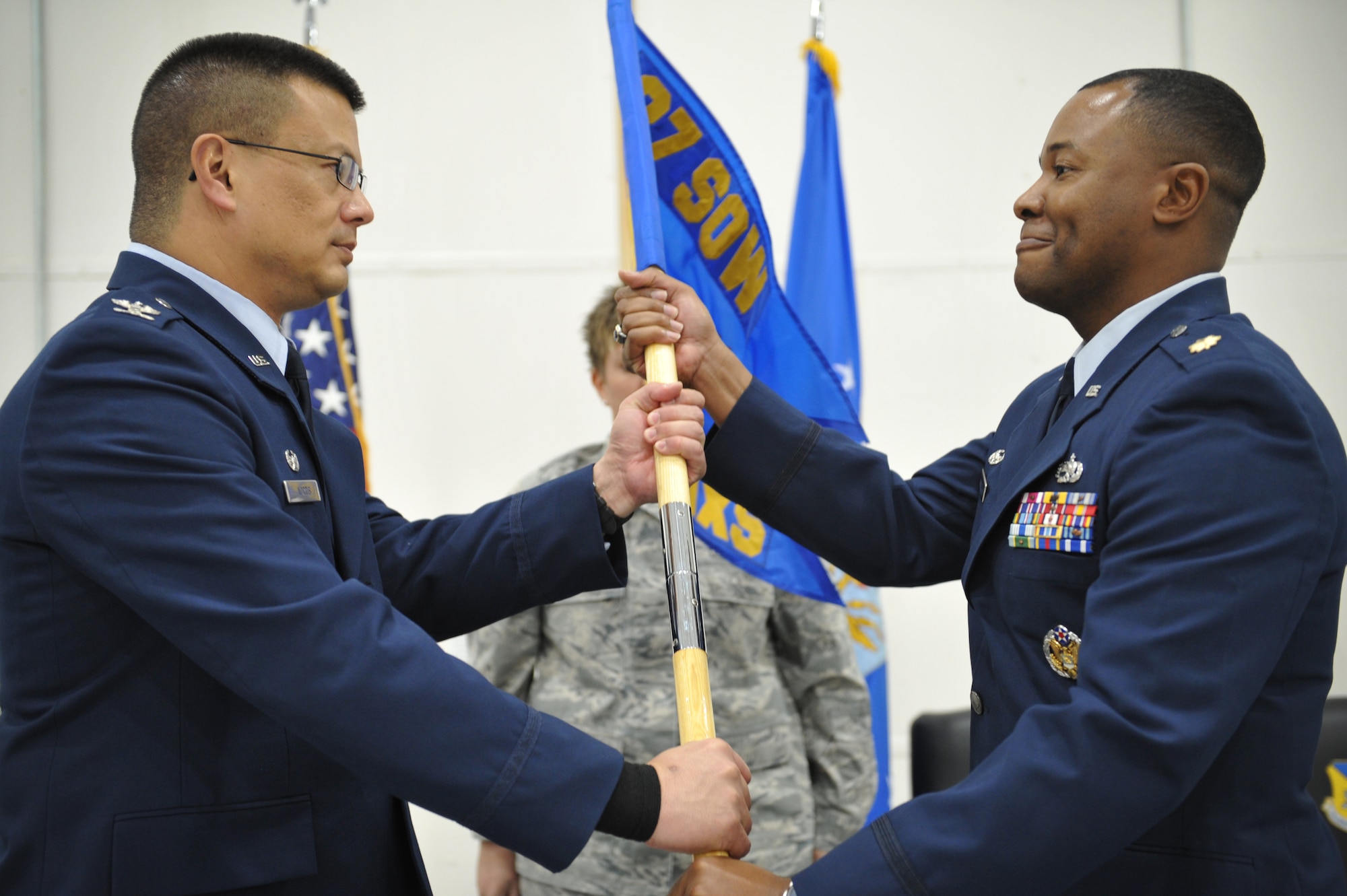 Col. Wesley Norris, left, 27th Special Operations Maintenance Group commander, passes the official squadron guide on to Maj. Marcus Brazell as he accepts command of the 727th Special Operations Aircraft Maintenance Squadron during an official squadron reorganization ceremony at Cannon Air Force Base, N.M., Jan. 24, 2012. (U.S. Air Force photo Tech. Sgt. Josef Cole)