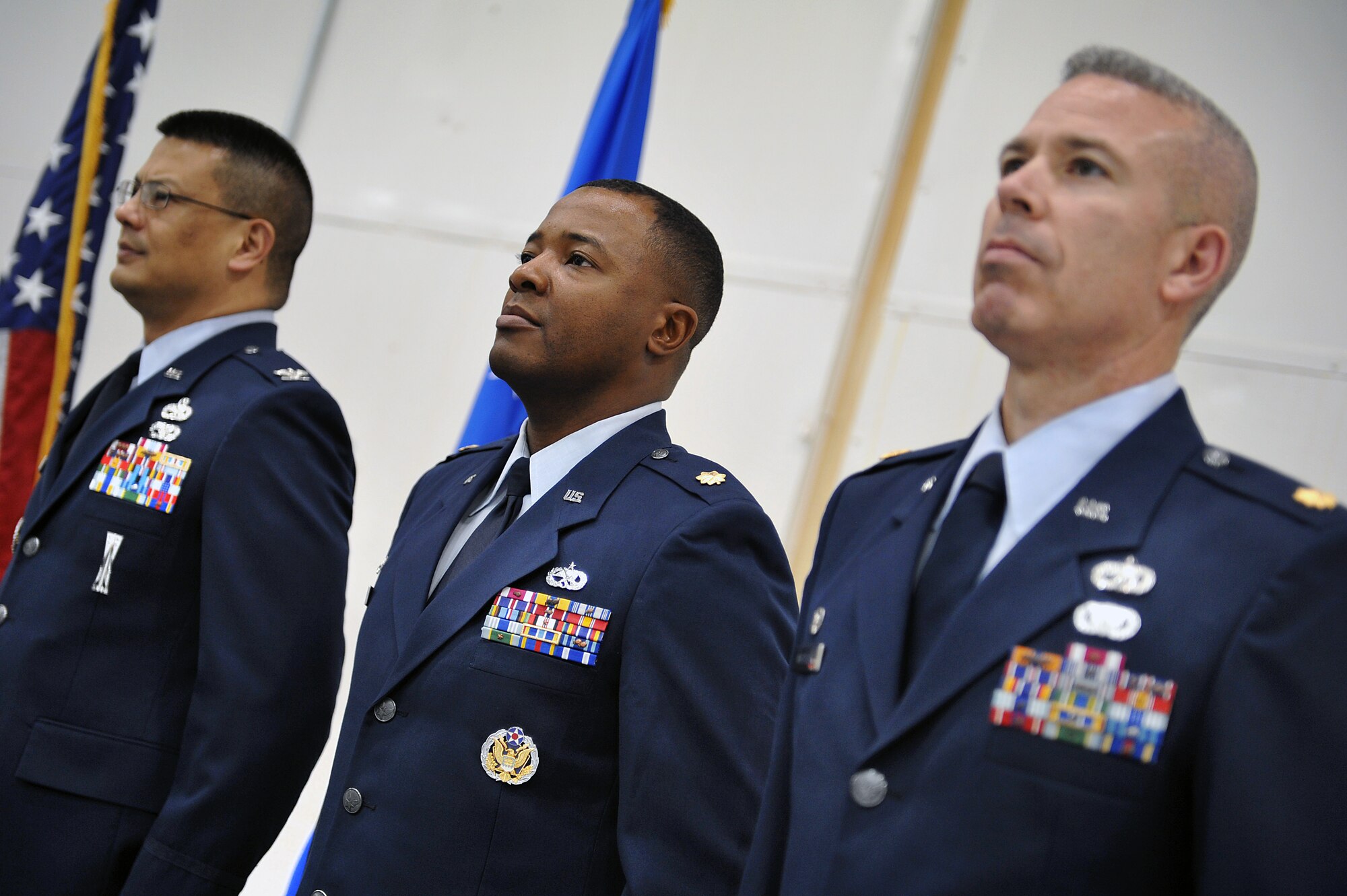 From left to right, Col. Wesley Norris, 27th Special Operations Maintenance Group commander, Maj. Marcus Brazell, 727th Special Operations Aircraft Maintenance Squadron commander, and Maj. Bernabe Whitfield, 27th Special Operations Maintenance Squadron commander, attend an official military ceremony for the reorganization of their commands at Cannon Air Force Base, N.M., Jan. 24, 2012. (U.S. Air Force photo Tech. Sgt. Josef Cole)