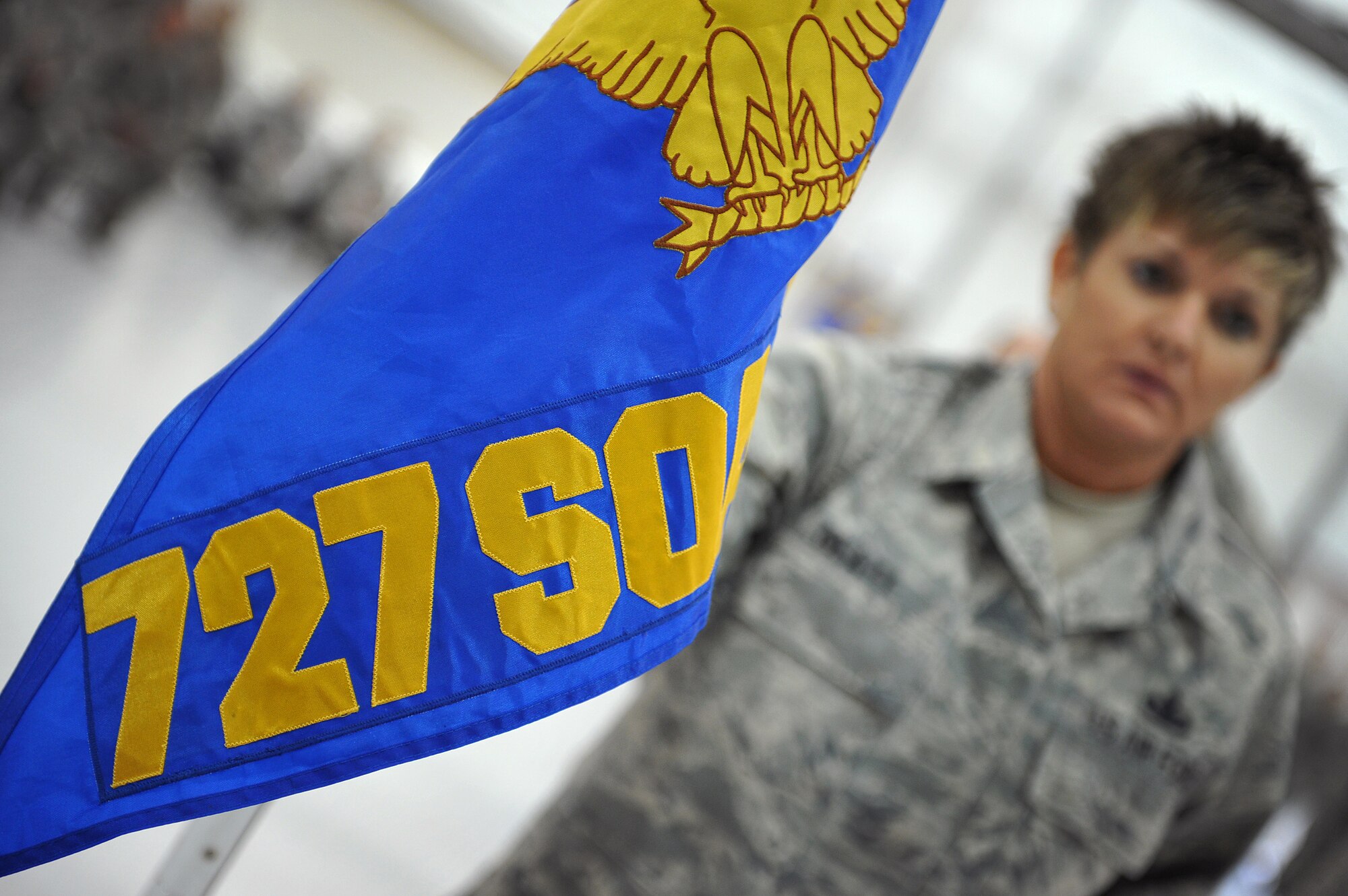 Master Sgt. Stacy Glatt, 727th Special Operations Aircraft Maintenance Squadron first sergeant, holds the guidon for the newly activated squadron during an official squadron reorganization ceremony at Cannon Air Force Base, N.M., Jan. 24, 2012. (U.S. Air Force photo Tech. Sgt. Josef Cole)