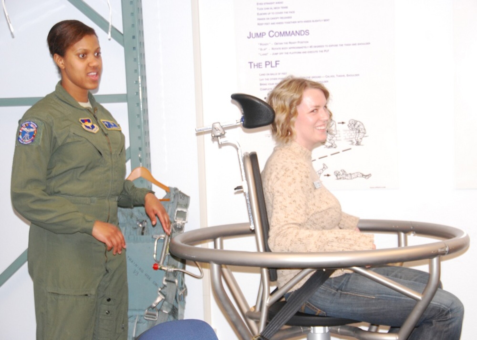 Airman 1st Class Jasmine Mudd-Smith, Aerospace Physiology technician, demonstrates how student pilots are trained on sensory perception and spatial orientation with the help of Shannon Rogers during a Leadership Wichita Falls tour of Sheppard Air Force Base Jan. 24, 2012. (U.S. Air Force photo/Debi Smith)