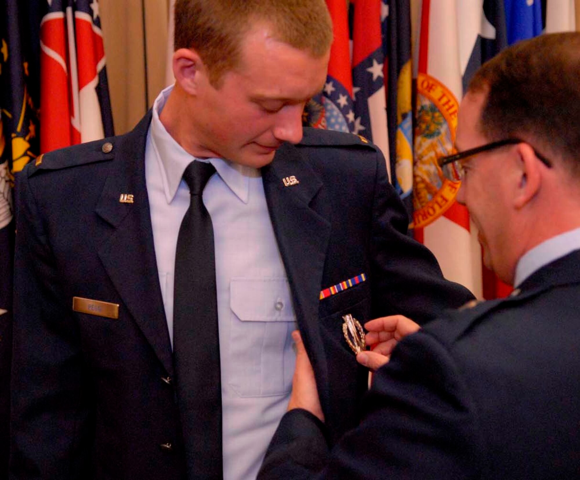 VANDENBERG AIR FORCE BASE, Calif. - Brig. Gen. Robert Rego, the mobilization assistant to the Global Strike Command commander, pins the Missile Badge with Operations Designator on 2nd Lt. Ethan Rego's service dress after Ethan's Initial Skills Training graduation at Vandenberg Air Force Base, Calif., Jan. 12. Ethan, the general's son, along with 27 other graduates, will serve as nuclear missile operators at F.E. Warren AFB, Wyo., Malmstrom AFB, Mont., or Minot AFB, N.D. (U.S. Air Force by 2nd Lt. Austin Fallin)