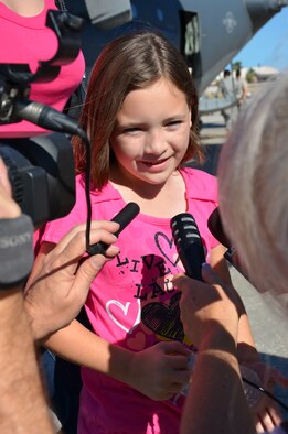 Master Sgt. Joel Lindsey's daughter hams it up for local news stations prior to her father, an electronic integrated systems supervisor for the 920th Rescue Wing, Patrick Air Force Base, Fla., deployed to the Horn of Africa Jan 25. Her father is among the 60 Rescue Reservists who will be deployed from the 920th in support of the ongoing search and rescue and humanitarian relief efforts there. (U.S. Air Force photo/Senior Airman Natasha Dowridge)
