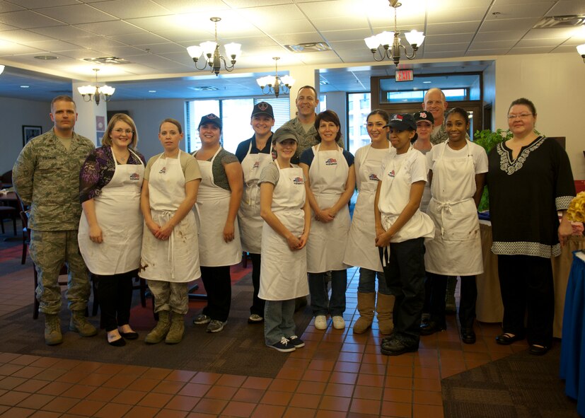Participants in the Cupcake Wars event join for a group photo after the event’s conclusion at the Georgia Pines Dining Facility, Jan. 24, 2012 at Moody Air Force Base, Ga. Five teams of two people competed to win over the taste buds of the judges. With a winter wonderland theme, each team had to create three types of cupcakes in just 70 minutes. All teams finished on time but it was Rachel Holder and Rebecca Gaddy of the “Tasty Tiger Baking Company” who took the crown. (U.S. Air Force photo by Senior Airman Eileen Meier/Released)