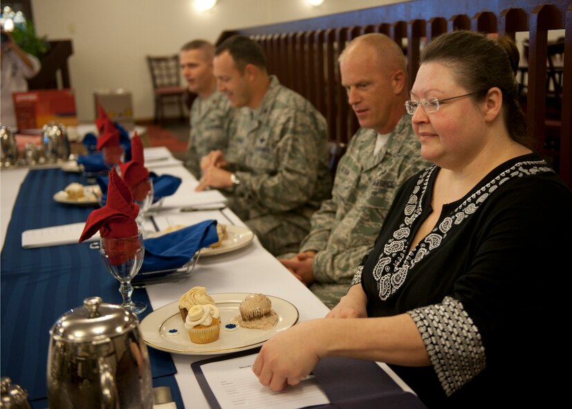 Judges of the Cupcake Wars event prepare to sample cupcakes from the first team, “Sass with Class,” at the Georgia Pines Dining Facility Jan. 24, 2012, at Moody Air Force Base, Ga. The judges (from left to right) were Maj. Brian Freeman, 23d Force Support Squadron commander, Col. Christopher Short, 23d Wing vice commander, Chief Master Sgt. Frank Batten, 23d Wing command chief, and Pam Kalil, owner of a bakery in downtown Valdosta. (U.S. Air Force photo by Senior Airman Eileen Meier/Released)