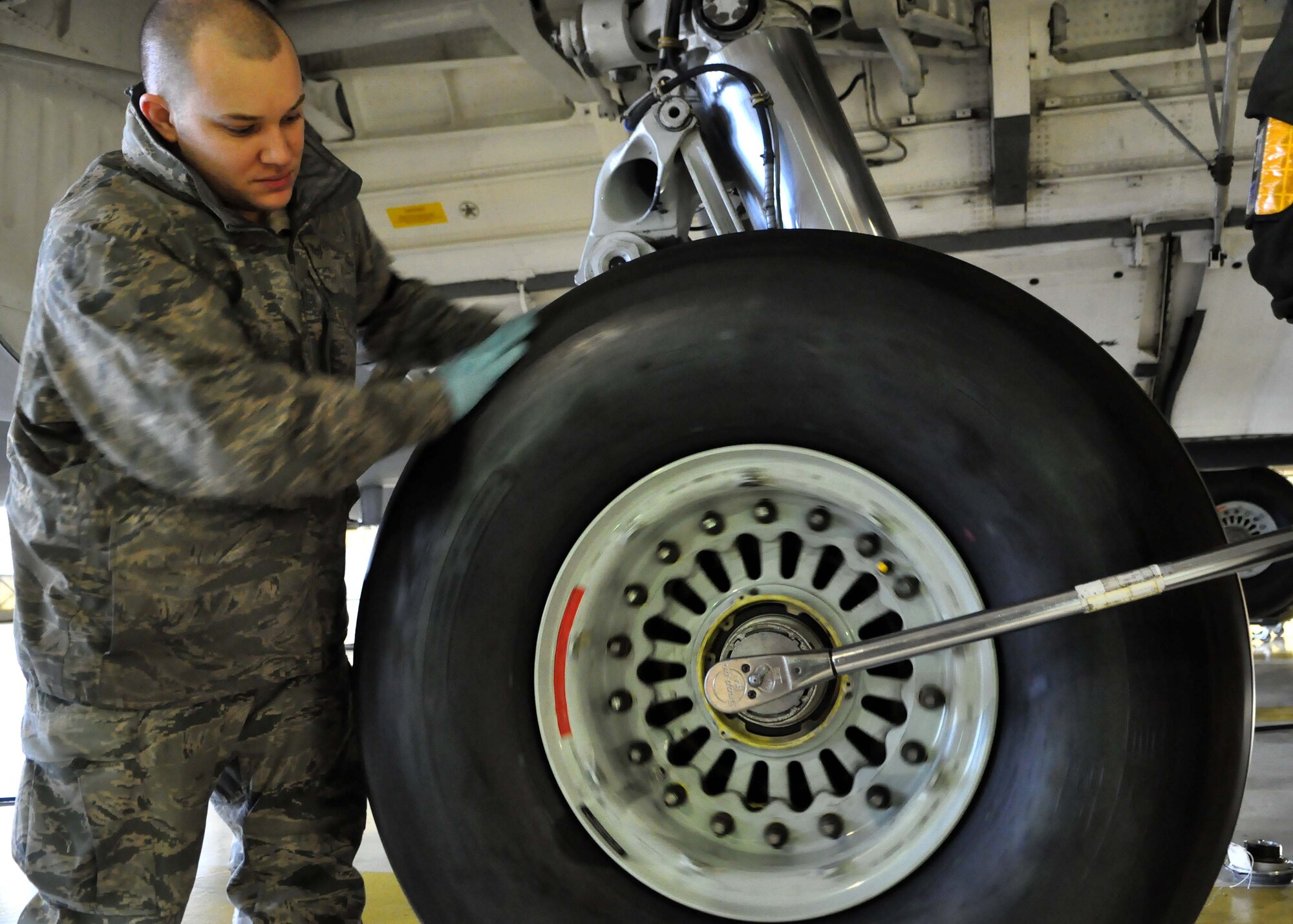Staff Sgt. Justin Miller, 62nd Aircraft Maintenance Squadron crew chief, stabilizes a tire of a C-17 Globemaster III as the final step in replacing the tire Jan. 17, 2012, at Joint Base Lewis-McChord, Wash. (U.S. Air Force photo/Airman 1st Class Leah Young)