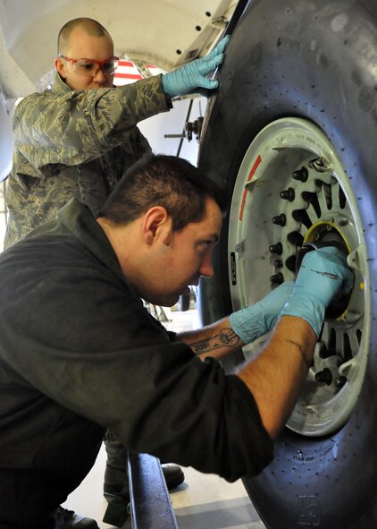 Staff Sgt. Justin Miller, left, 62nd Aircraft Maintenance Squadron crew chief, and Staff Sgt. Joshua Gallagher, 446th Aircraft Maintenance Squadron crew chief, tighten the final bolts on the tire of a C-17 Globemaster III Jan. 17, 2012, at Joint Base Lewis-McChord, Wash. (U.S. Air Force photo/Airman 1st Class Leah Young)