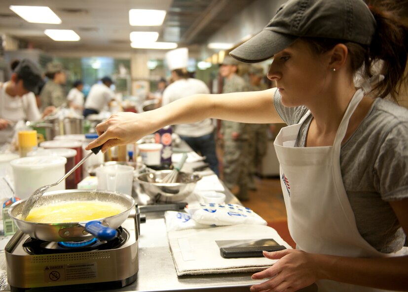 Jessica Wynne of team “Mind over Batter” melts butter during the Cupcake Wars held at the Georgia Pines Dining Facility Jan. 24, 2012 at Moody Air Force Base, Ga. The competition was to bake three types of cupcakes in one hour, beginning with an additional ten minutes for supply gathering. When the clock stopped, all cupcakes had to be plated and ready for the judges who consisted of base leadership and a member of the Valdosta community. (U.S. Air Force photo by Senior Airman Eileen Meier/Released)