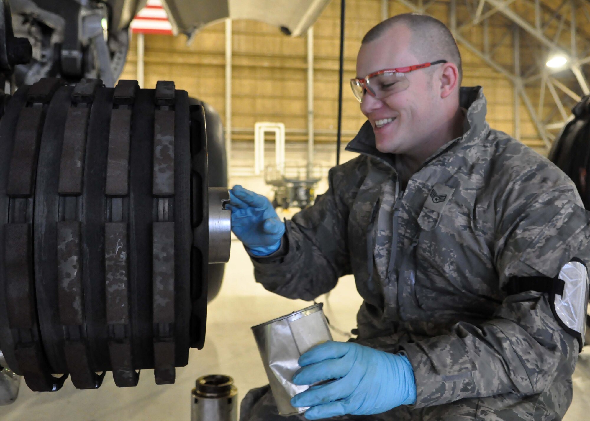Staff Sgt. Justin Miller, 62nd Aircraft Maintenance Squadron crew chief, applies grease to a C-17 Globemaster III axel before replacing a tire Jan. 17, 2012, at Joint Base Lewis-McChord, Wash. Changing tires is just one aspect of a C-17 Globemaster III’s routine maintenance. (U.S. Air Force photo/Airman 1st Class Leah Young)