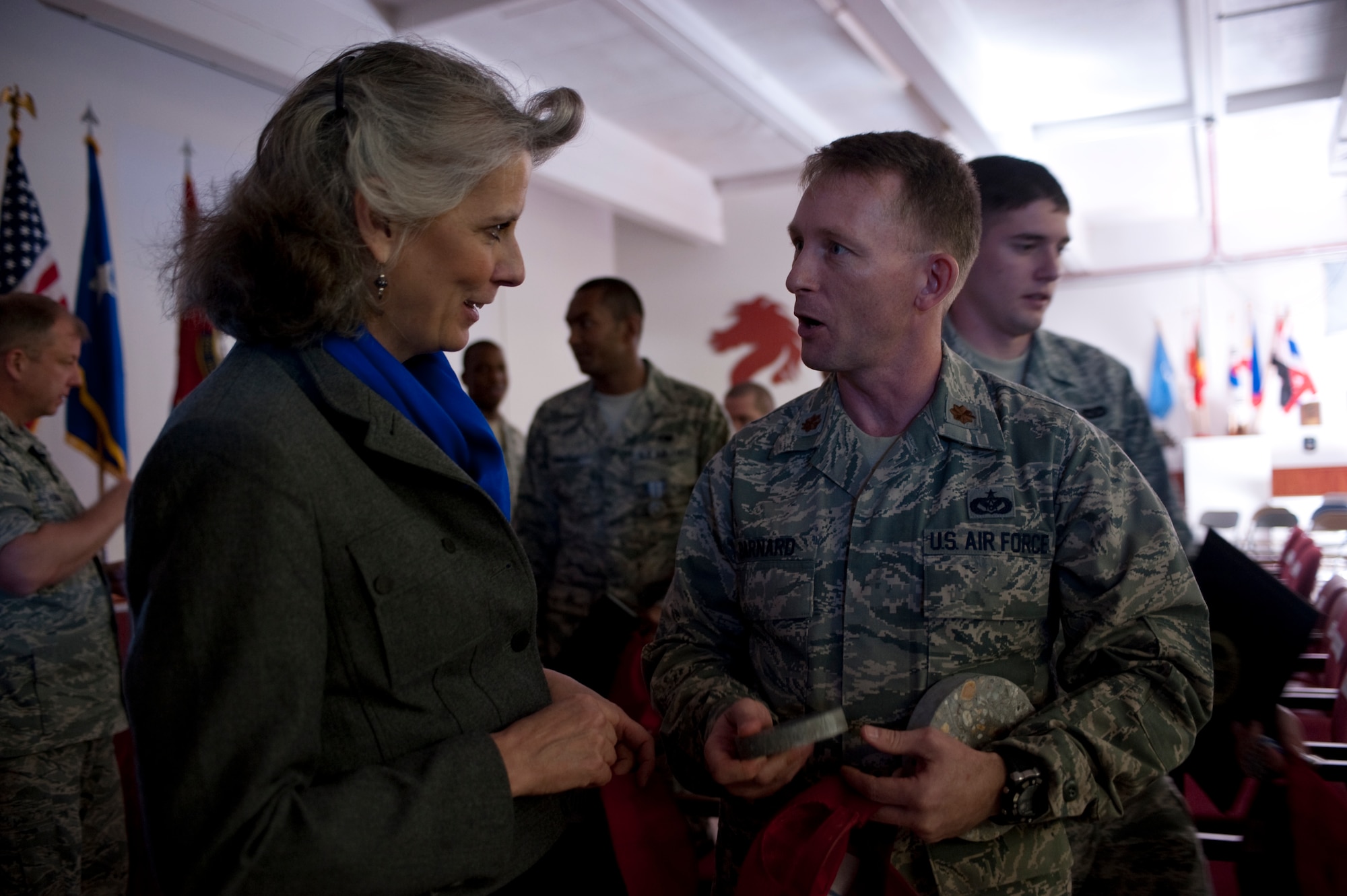 Kathy Wells, wife of U.S. Air Force Maj. Gen. Lawrence Wells, commander of the 9th Air Force, speaks with Maj. Timothy Barnard, engineering flight commander of the 823rd RED HORSE Squadron, during a visit to the squadron at Hurlburt Field, Fla., Jan. 20, 2012. Mrs. Wells and the general spoke with several Airmen about their careerfields while touring the squadron. (Air Force photo by Airman 1st Class Hayden Hyatt/Released)