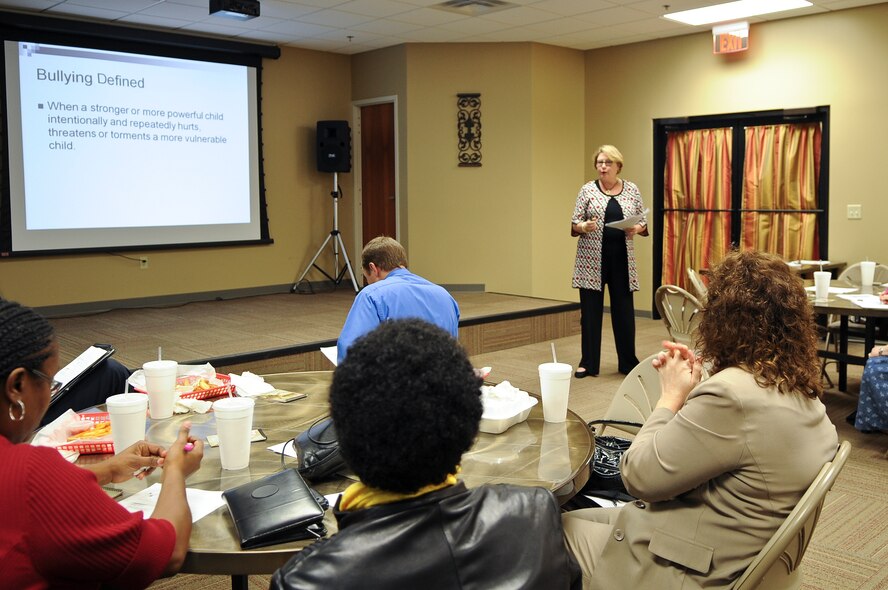 Susan B. Johnson, director of Program Development for Lowndes Drug Action Council, shares the definition of bullying during an anti-bullying luncheon at Moody Air Force Base, Ga., Jan. 25, 2012. Bullying is described as a deliberate or intentional hurtful action repeated by a powerful child towards a vulnerable child. (U.S. Air Force photo by Airman 1st Class Olivia Dominique/Released)