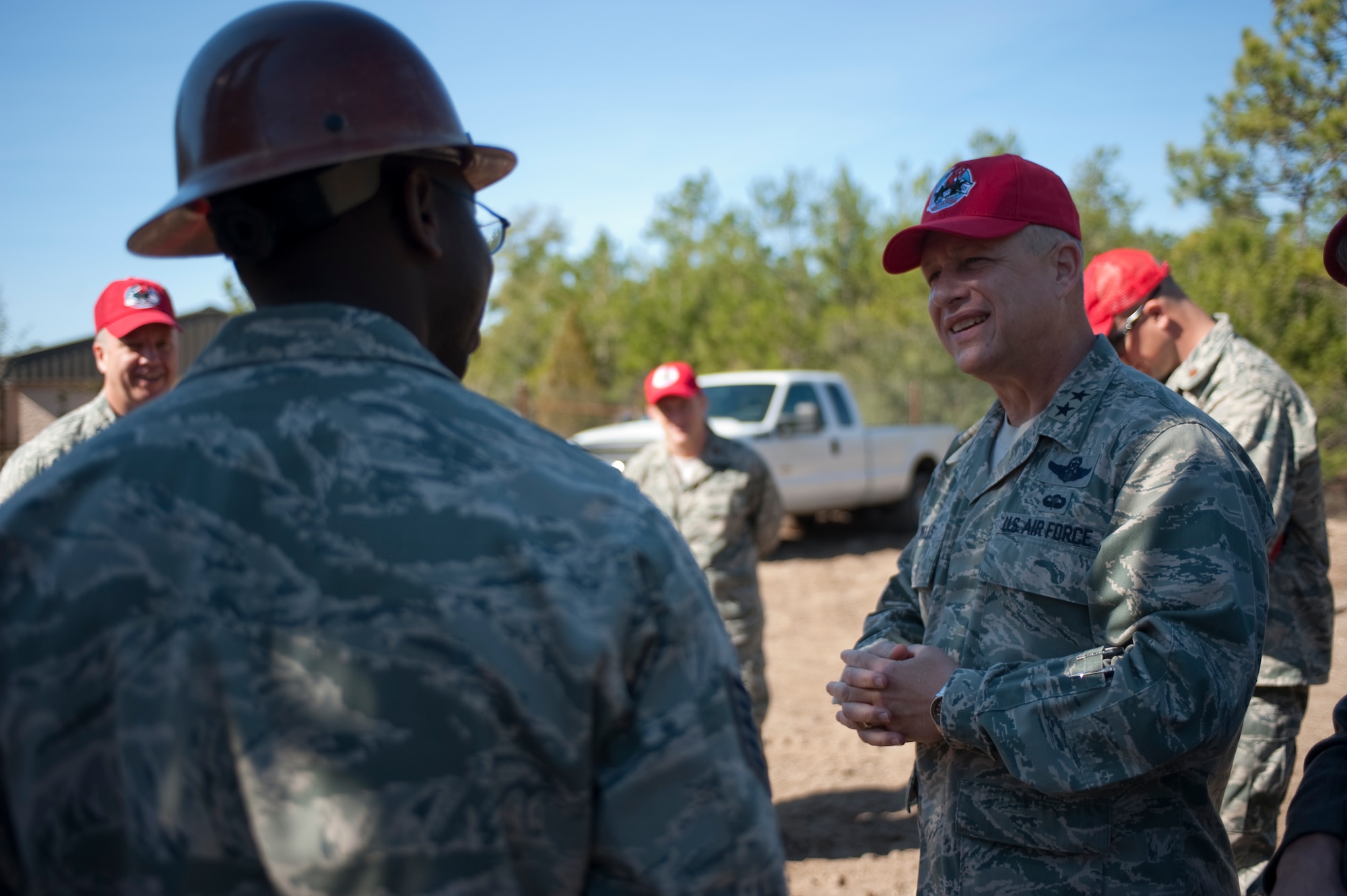 U.S. Air Force Maj. Gen. Lawrence Wells, commander of the 9th Air Force, speaks with 823rd RED HORSE Airmen while visiting outside the squadron at Hurlburt Field, Fla., Jan. 20, 2012. The squadron's rapidly-deployed training encompasses force beddown, convoy training, and advanced base recovery after attack, disaster preparedness, fire protection, explosive ordnance disposal, food service and lodging skills, chemical warfare operations and personnel accountability.  (Air Force photo by Airman 1st Class Hayden Hyatt/Released)
