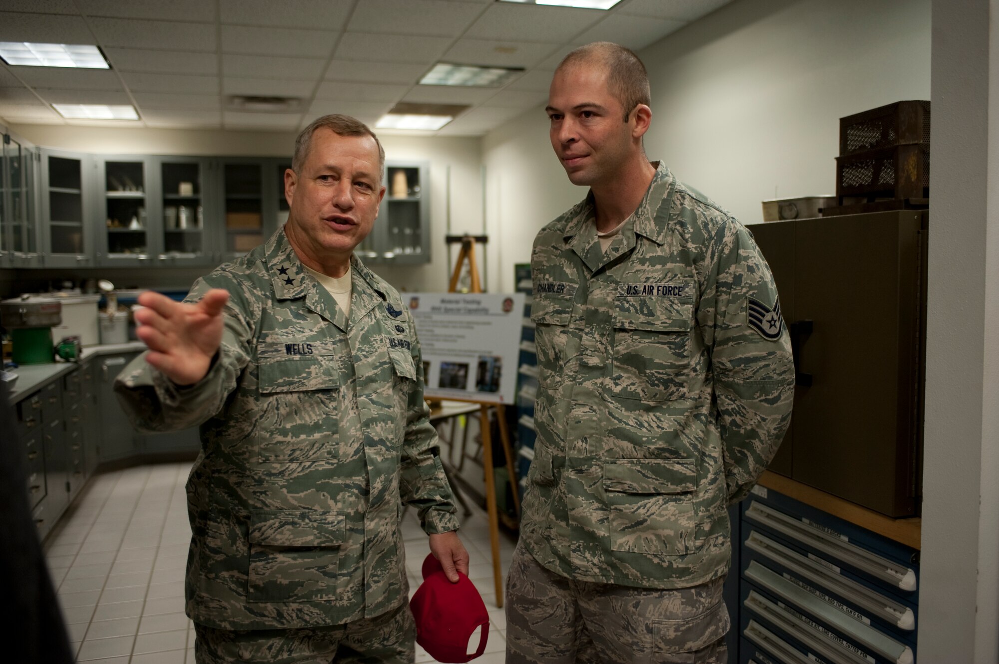 U.S. Air Force Maj. Gen. Lawrence Wells, commander of the 9th Air Force, speaks with Staff Sgt. Matthew Chandler, an engineering assistant of the 823rd RED HORSE Squadron, while touring the squadron's facility at Hurlburt Field, Fla., Jan. 20, 2012. The general also visited different sections of the squadron including vehicle maintenance, a well-drilling rig and the gymnasium.  (Air Force photo by Airman 1st Class Hayden Hyatt/Released)