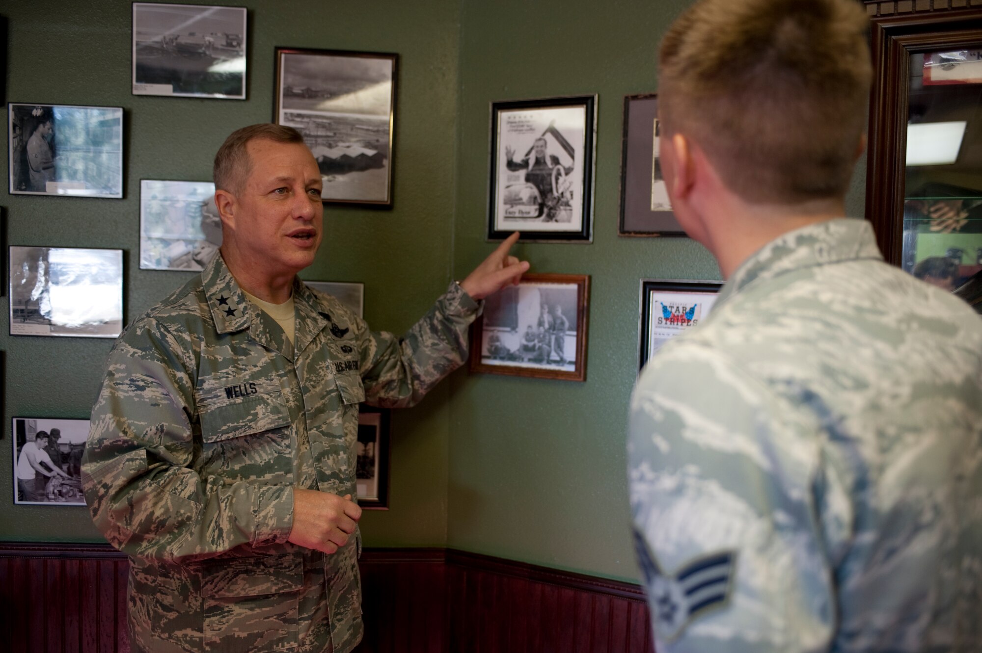 U.S. Air Force Maj. Gen. Lawrence Wells, commander of the 9th Air Force, points to a photo while being briefed by Senior Airman Kody Hopper, an equipment operator from the 823rd RED HORSE Squadron, at the squadron's museum at Hurlburt Field, Fla., Jan. 20, 2012. As commander, the general leads seven active-duty wings and two direct reporting units in the eastern United States with more than 350 aircraft, and 24,000 active-duty and civilian personnel. (Air Force photo by Airman 1st Class Hayden Hyatt/Released)