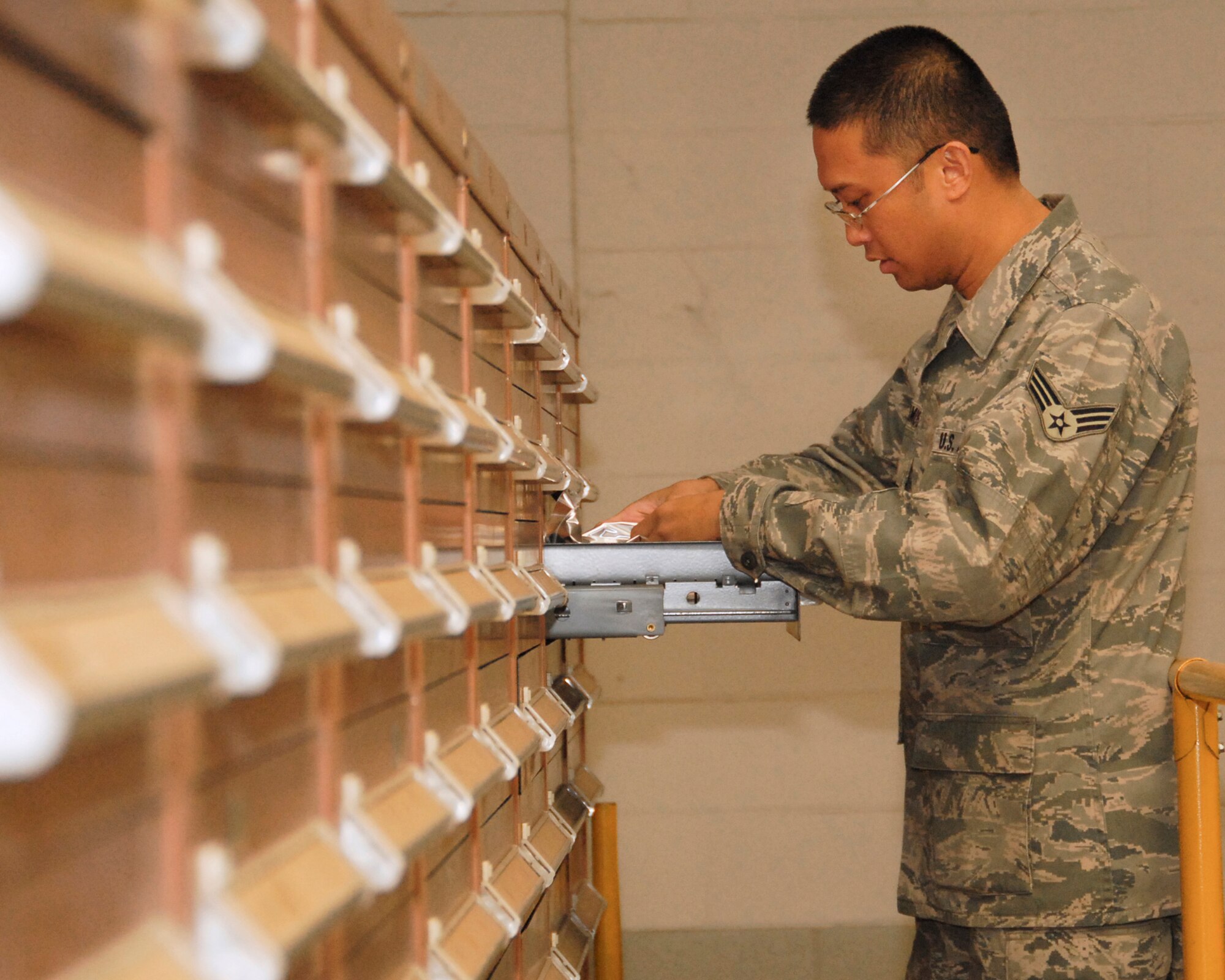 Airman of the Month Senior Airman Edwin Ramos, a Material Handler and Protective Equipment Custodian, examines and organizes a drawer in the supply bay at the 146th Channel Islands Air National Guard Station, Port Hueneme California on January 8, 2012. (U.S. Air Force photo by: SrA Nicholas Carzis)