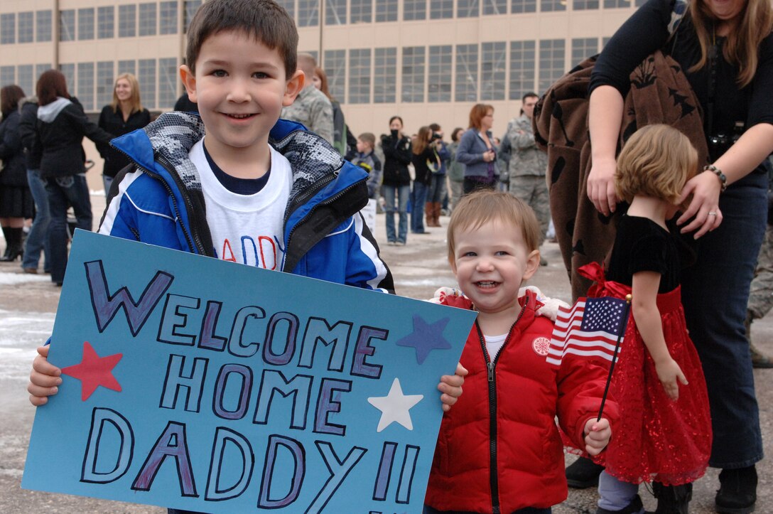 Zachary and Rebekah Ferron, awaits the return of their father Senior Airman Brandon Ferron, 34th Air Maintenance Squadron weapons loader at the Pride Hanger at Ellsworth Air Force Base, S.D., Jan. 25, 2012. Airmen returned home from a six-month deployment of supporting mission operations in Southwest Asia. (U.S. Air Force photo by Airman 1st Class Zachary Hada/Released)