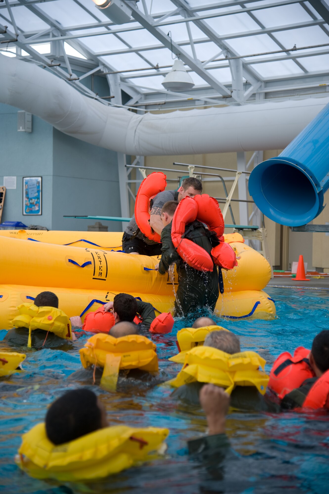 Students learn how to climb into a raft during a water survival class Jan. 24. (U.S. Air Force photo/Airman 1st Class Nicole Leidholm)