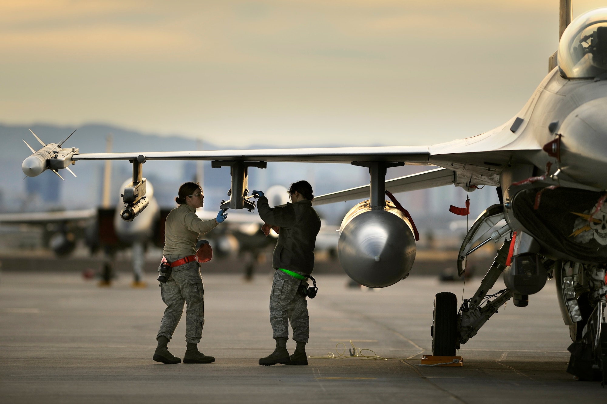 Sr. Airmen Nancy Bartel and Diana Medina, both back-shop armament technicians, post flight an F-16 on day two of Red Flag 12-2 Jan. 24 at Nellis Air Force Base, Nev. Coalition partners from South Korea and Saudi Arabia participated in the joint training exercise that's been around since 1975. (USAF photo by Master Sgt. Ben Bloker)
