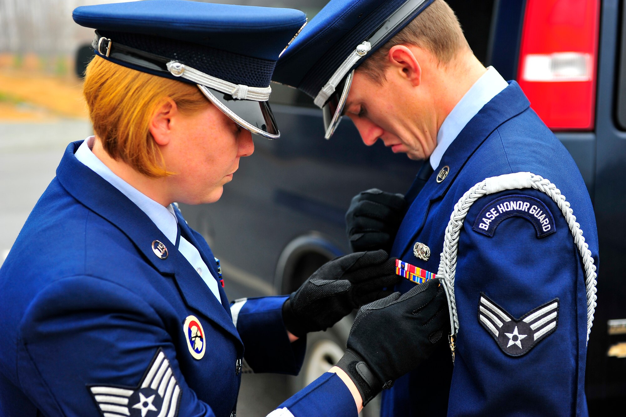U.S. Air Force Tech Sgt. Rachel Hill, Honor Guard noncommissioned officer in charge, checks over her Airmen’s uniforms, right before a funeral service at Shaw Air Force Base, S.C. Jan. 23, 2011. Shaw’s Honor Guard provides funeral service details, and other services to four states, 75 counties, and approximately five million residents.  (U.S. Air Force photo/Senior Airman Neil D. Warner)(Released)