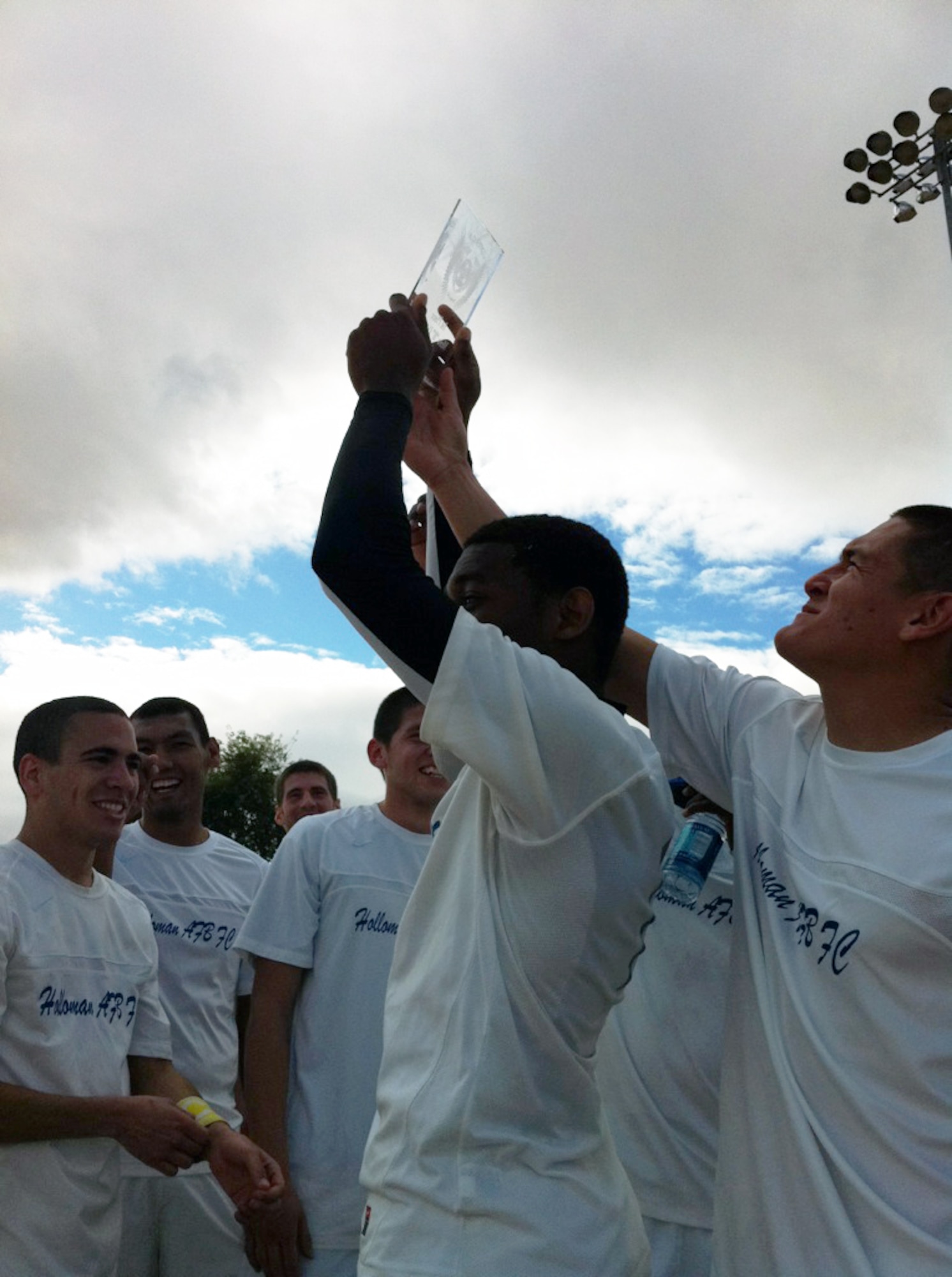 TEMPE, Ariz. -- Dayne Griffiths and Jair Mendoza Vargas, Holloman Varsity Soccer team members, hold up the Copper Cup Tournament championship trophy Jan.16, after the Raptors defeated the Arizona-based Flagstaff Ravens 2-0 in the championship match. Eighteen members of the Holloman community, including members from both the German Air Force and the U.S. Air Force, traveled seven hours to compete in the tournament that fielded 59 teams in multiple divisions. (Courtesy Photo)