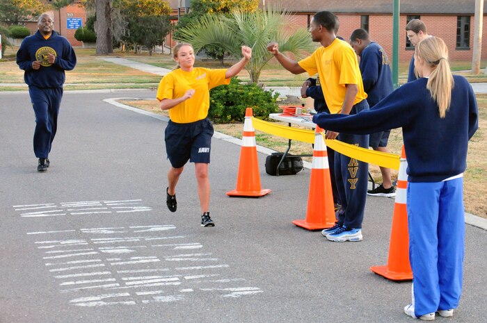 Petty Officer 2nd Class April Butler is cheered on by shipmates as she finishes the Road Rage challenge at Joint Base Charleston - Weapons Station, Jan. 25.  The Road Rage is a five kilometer race sponsored by Morale, Welfare and Recreation in order to promote healthy lifestyles to service members. Butler is a Ship’s Serviceman at the JB Charleston – Weapons Station Unaccompanied Personnel Housing office. (U.S. Navy photo/Petty Officer 2nd Class Brannon Deugan)